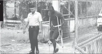  ??  ?? Edward Gudge being escorted by police after appearing at the Vreed-en-Hoop Magistrate’s Court, where he pleaded not guilty to armed robbery.