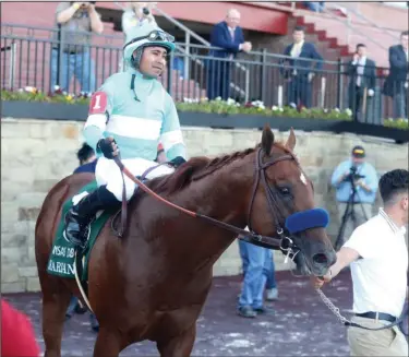  ?? The Sentinel-Record/Richard Rasmussen ?? THE REAL DEAL: Jockey Martin Garcia and Charlatan head into the winner’s circle after winning the first division of the Arkansas Derby Saturday at Oaklawn Racing Casino Resort.