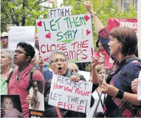  ?? Photo: AFP ?? People hold up placards at a protest outside an immigratio­n office in Sydney on February 4, 2016.