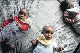  ??  ?? Babes in bed: The Finnish baby box (right) was introduced in the 1930s when the country was poor, had a low standard of living and infant and child mortality was high. Below, a baby in a Kenyan version, the Toto Care Box.