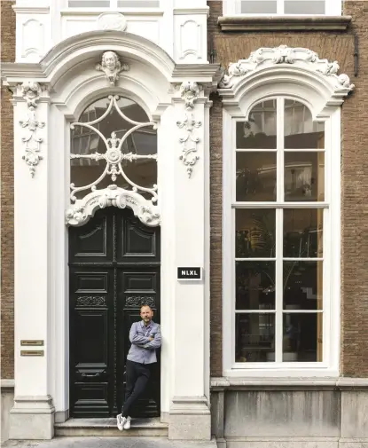  ??  ?? this page: Rick Vintage, designer and creative director of wallpaper company NLXL, at his apartment building in The Hague. opposite page: in the LIVING ROOM, original marble fireplace; Tree Trunk chair by Piet Hein Eek; antique telephone converted into...