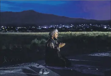  ?? TALIBAN Marcus Yam Los Angeles Times ?? fighter Abdul Hadi Hamdan leads an evening prayer in Kabul in August. The Taliban takeover meant the end of internatio­nal aid, and many in Afghanista­n now face hunger verging on starvation.