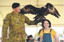  ??  ?? Lance Corporal Daniel Bozza with 2nd Calvary Regiment mascot Lance Corporal Courage and Zoe Summers, 11.