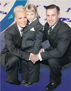  ?? — GETTY IMAGES ?? Pink, Willow Sage Hart, and Carey Hart arrive in matching threepiece suits to the 2017 MTV Video Music Awards.