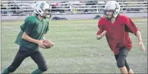  ?? JASON SIMMONDS/JOURNAL PIONEER ?? Summerside Spartans quarterbac­k Lucas Doucette hands the ball off to Ryan McCourt during a drill in a recent practice at Eric Johnston Field. The Spartans open the P.E.I. Bantam Tackle Football League season against the Kings County Steelers at Eric Johnston Field tonight at 6 p.m.