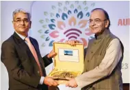  ?? - PTI ?? ELATED: Union Finance Minister Arun Jaitley receiving memento from Comptrolle­r and Auditor General Shashi Kant Sharma at XXIII Commonweal­th Auditors General Conference in New Delhi on Wednesday.