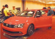  ??  ?? A Volkswagen turns some heads at a New Mexico Internatio­nal Auto Show.