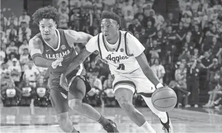  ?? AP ?? Texas A&M guard Wade Taylor IV drives the lane against Alabama guard Mark Sears during the second half on Saturday in College Station, Texas.