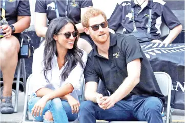  ??  ?? Prince Harry sits with Markle to watch an event during the Invictus Games in Toronto, Canada last Sept 25. — Reuters file