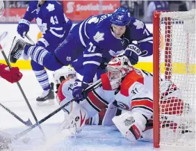  ?? FRANK GUNN/The Canadian Press ?? Carolina Hurricanes goalie Anton Khudobin makes a save on Toronto Maple Leafs
David Clarkson during the second period in Toronto on Monday.