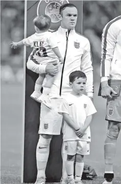  ??  ?? England’s forward Wayne Rooney is pictured during the national anthem ahead of the Euro 2016 Qualifier, Group E football match between England and Slovenia atWembley in north London. - AFP photo