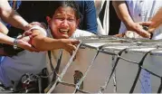  ?? Bullit Marquez / Associated Press ?? Jessica Demafelis, sister of Joanna Demafelis, a maid murdered in Kuwait, cries as Joanna’s casket arrives.