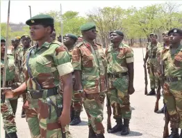  ??  ?? Colonel Edgar Dube from HQ 1 Infantry Brigade inspects a parade mounted by ZNA graduates at 1.2 Infantry Battalion in Hwange