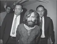  ?? AP PHOTO, FILE ?? In this 1969 photo, Charles Manson is escorted to his arraignmen­t on conspiracy-murder charges in connection with the Sharon Tate murder case.