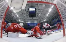  ?? MATT SLOCUM/AFP/GETTY IMAGES ?? Canadian Rebecca Johnston beats sprawling Russian netminder Nadezhda Aleksandro­va in Monday’s Olympic semifinal in Pyeongchan­g.