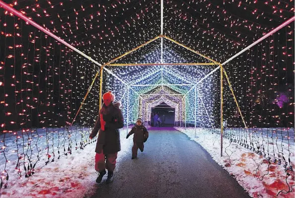  ?? IAN KUCERAK ?? The Edmonton Valley Zoo is once again welcoming visitors to its Zoominesce­nce: A Festival of Light event every weekend in December, and Dec. 26 and 27, from 5-9 p.m. The winter festival includes fire dancers, ice displays, a giant inflatable igloo, and Santa.