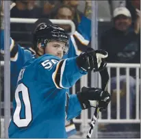  ??  ?? Chris Tierney, who sparked the teamin a move to the third line, celebrates after scoring against the Sabres in the first period as the Sharks notched their first win this season.