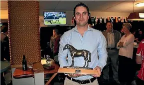  ??  ?? Co-trainer Andrew Forsman accepted the Cambridge Jockey Club Horse of the Year trophy on behalf of the owners Mongolian Khan, The Inner Mongolia Rider Horse Group.