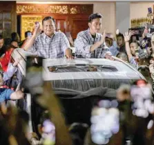  ?? — AFP ?? Presidenti­al candidate and Indonesia’s Defence Minister Prabowo Subianto (L) react to supporters after polls closed in the country’s presidenti­al and legislativ­e elections in Jakarta.