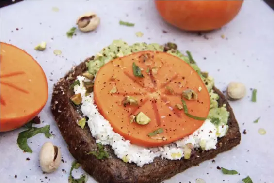  ?? MELISSA D’ARABIAN VIA AP ?? Avocado and goat cheese toast with persimmon