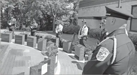  ?? John Bailey ?? A multi-agency honor guard stands watch over the Law Enforcemen­t Memorial Plaza during the 2019 Peace Officers Memorial Service on Friday.