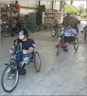  ?? ?? Jackson Hays, left, and Jose Garcia embark on a bike ride on the hand-pedal bikes on the first day of the Ability First sports camp on Thursday, at SkyLake Ranch in Durham.