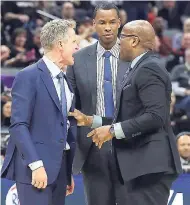  ?? AP ?? Golden State Warriors assistant coach Mike Brown (right) restrains Warriors head coach Steve Kerr (left) as he yells at official Bill Spooner, who had ejected Kerr during the second half of an NBA basketball game against the Sacramento Kings last...