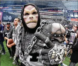  ??  ?? An Oakland Raiders fan joins others on the field during the final day of the 2018 NFL Draft at AT&T Stadium in Arlington, Texas, on Saturday.