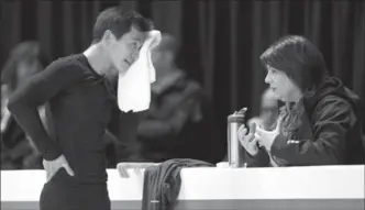  ?? PAUL CHIASSON, THE CANADIAN PRESS ?? Patrick Chan wipes his face as he listens to his coach Kathy Johnson during a practice session at the World Figure Skating Championsh­ips in March 2013.