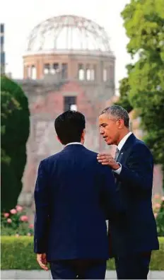  ?? AFP ?? US Presdent Barack Obama puts his hand on the shoulder of Japanese Prime Minister Shinzo Abe at the Hiroshima Peace Memorial Park, yesterday.