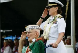  ?? ASSOCIATED PRESS ?? EVERETT HYLAND, SEATED, WHO SURVIVED THE ATTACK on Pearl Harbor as a crew member of the USS Pennsylvan­ia, salutes along with his granddaugh­ter Navy Cmdr. Anna-Marie Fine on Friday as the USS Michael Murphy passes in Pearl Harbor, Hawaii during a ceremony marking the 77th anniversar­y of the Japanese attack. The Navy and National Park Service jointly hosted the remembranc­e ceremony at a grassy site overlookin­g the water and the USS Arizona Memorial.