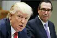  ?? EVAN VUCCI — THE ASSOCIATED PRESS FILE ?? In this file photo photo, Treasury Secretary Steven Mnuchin listens at right as President Donald Trump speaks during a meeting on the Federal budget in the Roosevelt Room of the White House in Washington.