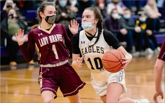  ?? James Franco / Special to the Times Union ?? Duanesburg senior Madison Meyer drives to the basket in front of Fonda senior Kyla Smith during a Western Athletic Conference matchup at Duanesburg High School on Dec. 10. Meyer earned tourney most valuable player honors after scoring 19 points in the title-winning Class C sectionals.