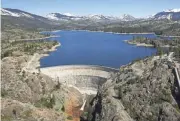  ?? RICH PEDRONCELL­I/AP ?? Monday photo of the PG&E hydroelect­ric dam at Spaulding Lake shows the snow-covered Sierra Nevada beyond the lake.
