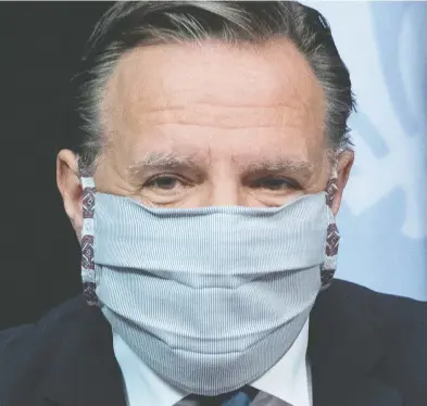  ?? JACQUES BOISSINOT / THE CANADIAN PRESS ?? Quebec Premier François Legault arrives at a news conference on the COVID-19 pandemic wearing a mask Tuesday.