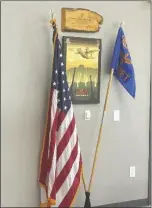  ?? ?? A PLAQUE AND FLAGS PAYING HOMAGE to the United States Army Special Operations Aviation Command Flight Detachment, which will utilize the hangar.