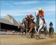  ?? PHOTO COURTESY NYRA ?? This scene will be repeated almost 400 times as top horses and jockeys make their way around the final turn on to the finish line at historic Saratoga Race Course.