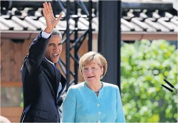  ?? AFP ?? US President Barack Obama waves as he stands with Germany’s Chancellor Angela Merkel after delivering a speech upon arrival for a meeting with local citizens in Kruen near Garmisch-Partenkirc­hen, southern Germany, yesterday before the start of a G7...