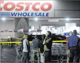  ?? Will Lester The Associated Press ?? A Costco employee talks on the phone following a shooting inside the wholesale outlet in Corona, Calif., on Friday. The incident involved an off-duty police officer.