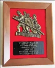  ?? MARK PODOLSKI - THE NEWS-HERALD ?? A plaque in Billy Wagner’s Madison home signifies his 29 years of service for the Euclid Fire Department.