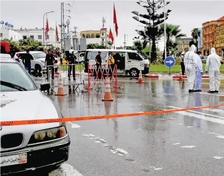  ?? AFP ?? Tunisian forensic police investigat­e the site of an attack on Tunisian National Guard officers killing one policeman, on Sunday, in Sousse, south of Tunis.