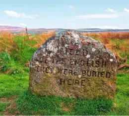  ??  ?? Worn by time and coloured with lichen, a headstone marks the resting place of English soldiers on the battlefiel­d.