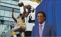  ?? REED SAXON — THE ASSOCIATED PRESS FILE ?? Elgin Baylor stands next to a statue honoring the Minneapoli­s and Los Angeles Lakers great in 2018. Baylor, the Lakers’ 11-time NBA All-Star, died Monday of natural causes. He was 86.