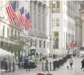  ?? MARK LENNIHAN/AP ?? People walk by the New York Stock Exchange last month.