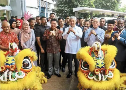  ?? ?? Best wishes: Flanking ahmad Zahid (in white) are Nga and Fadillah, with other ministers and officials at the Local Government developmen­t Ministry’s CNY celebratio­n in Putrajaya. — FAIHAN Ghani/the Star