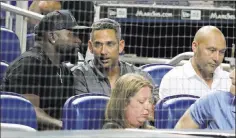  ??  ?? Derek Jeter, part owner of the Marlins, right, sits with former teammate Jorge Posada, center, and former rival David Ortiz during Monday’s game.