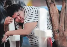  ?? SCOTT OLSON, GETTY IMAGES ?? Family, friends and neighbours mourn the loss of eight people, including six children, who perished in an early-morning fire on Sunday in Chicago. Two victims of the fire remain in hospital in critical condition.