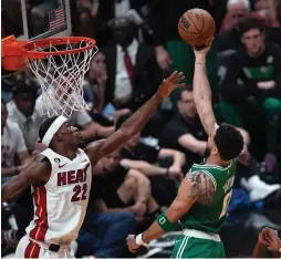  ?? (Jim Rassol/USA Today Sports) ?? BOSTON CELTICS forward Jayson Tatum shoots over the Miami Heat’s Jimmy Butler for two of his game-high33 points in the Celtics’ 116-99 season-saving victory over the host Heat in Game 4 of the Eastern Conference finals, which Miami still leads 3-1.