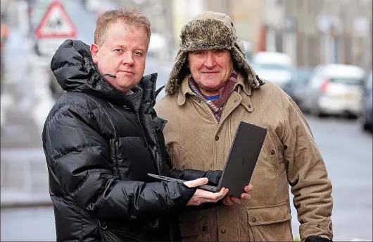  ??  ?? Disappoint­ed: Angus Anderson, of Dufftown, with the laptop he bought for his father-in-law, Tony Austin