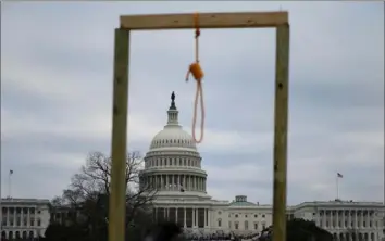  ?? Andrew Caballero-Reynolds/AFP via Getty Images ?? A noose hangs on a makeshift gallows outside the U.S. Capitol on Wednesday as a proTrump mob storms the “People's House” in an attempt to prevent President-elect Joe Biden's certificat­ion.